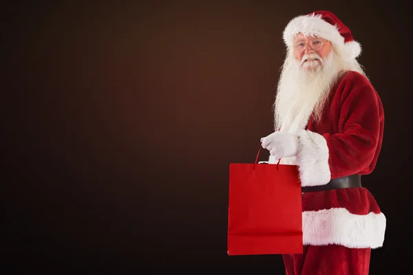 Složený obraz Santa nese červená taštička — Stock fotografie