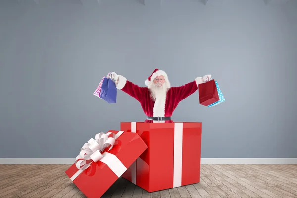 Santa standing in large gift — Stock Photo, Image