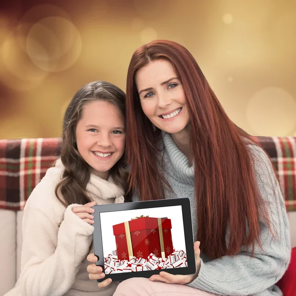 Mother and daughter showing tablet — Stock Photo, Image