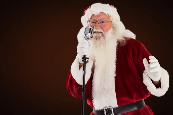Santa claus is singing christmas songs — Stock Photo, Image