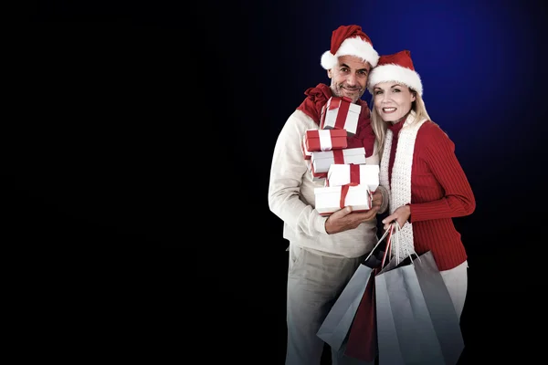 Happy festive couple with gifts and bags — Stock Photo, Image