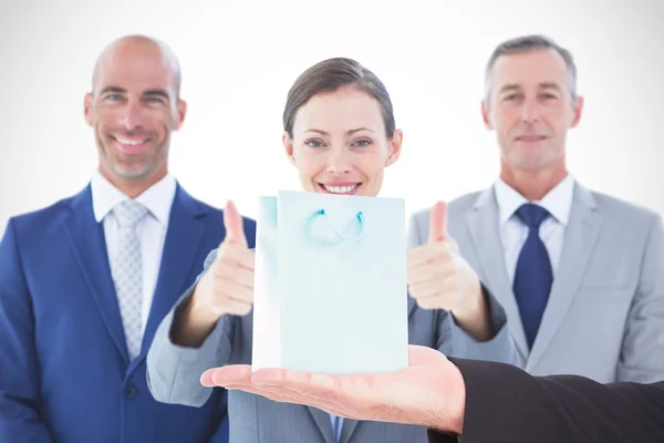 Businessman holding hand out in presentation — Stock Photo, Image