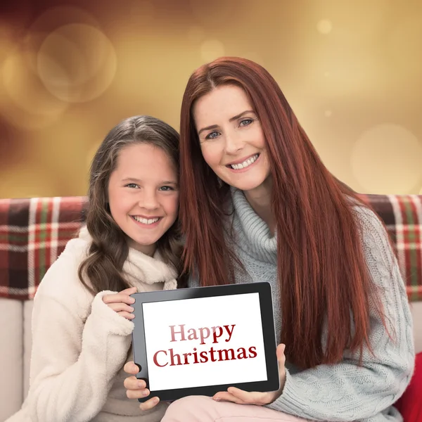 Mother and daughter showing tablet — Stock Photo, Image