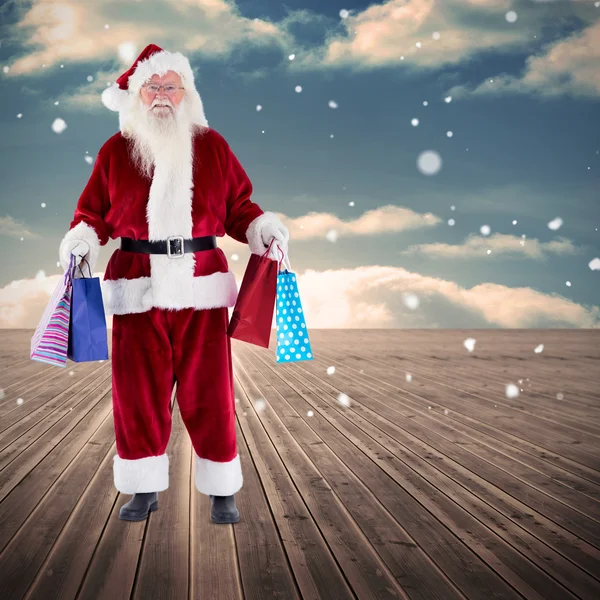 Santa carrying gifts — Stock Photo, Image