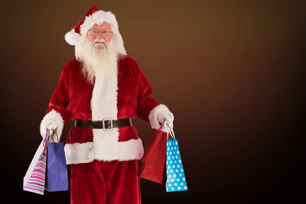 Santa carries some christmas bags — Stock Photo, Image