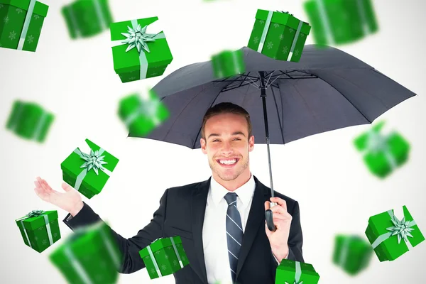 Sammansatt bild av affärsmannen skyddande under svart paraply — Stockfoto