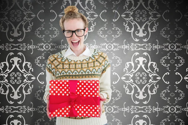 Excited geeky hipster holding present — Stock Photo, Image