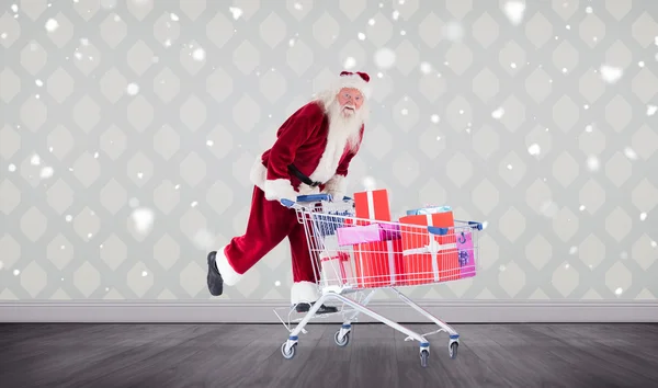 Immagine composita di Santa spingendo carrello della spesa — Foto Stock