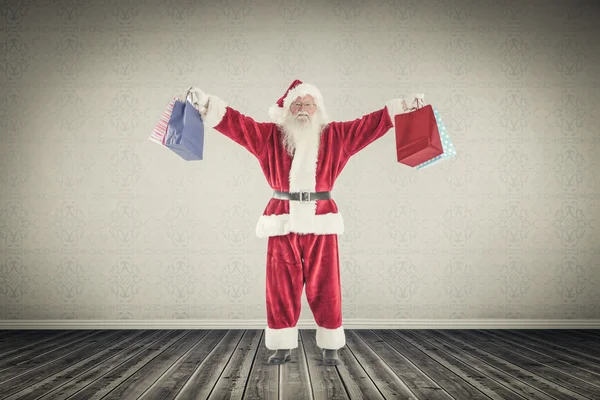 Zusammengesetztes Bild des Weihnachtsmannes, der Geschenke trägt — Stockfoto