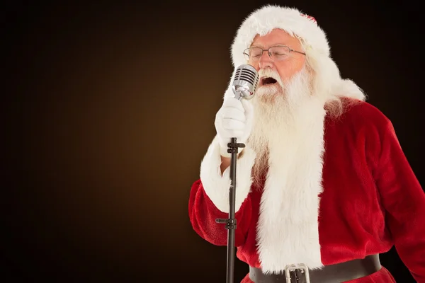 Santa claus is singing christmas songs — Stock Photo, Image