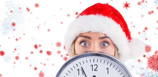 Festive blonde showing a clock — Stock Photo, Image