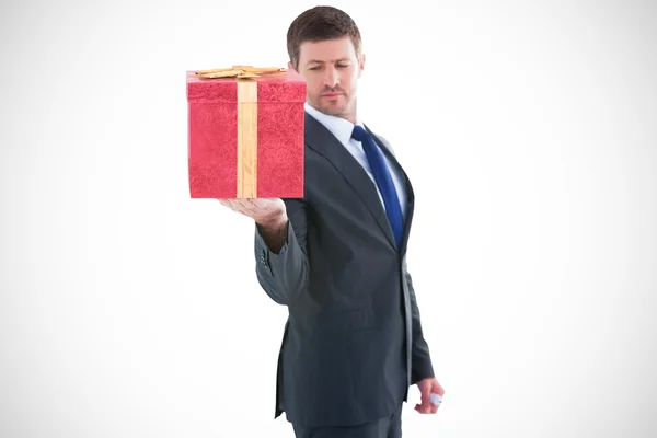 Businessman holding hand out in presentation — Stock Photo, Image