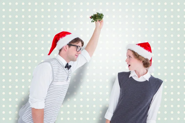 Geeky hipster holding mistletoe — Stock Photo, Image