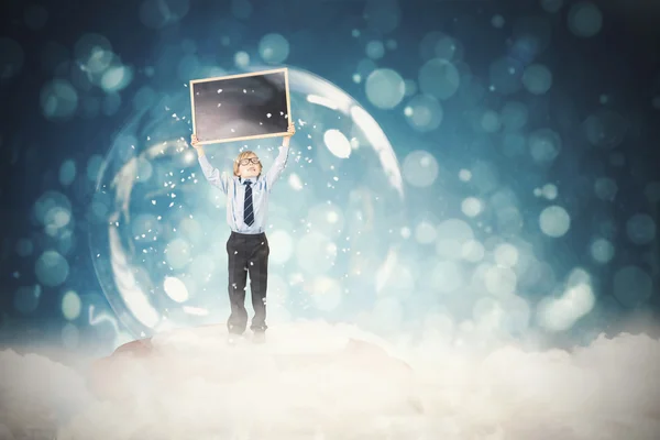 Imagen compuesta de niño festivo en bola de nieve — Foto de Stock