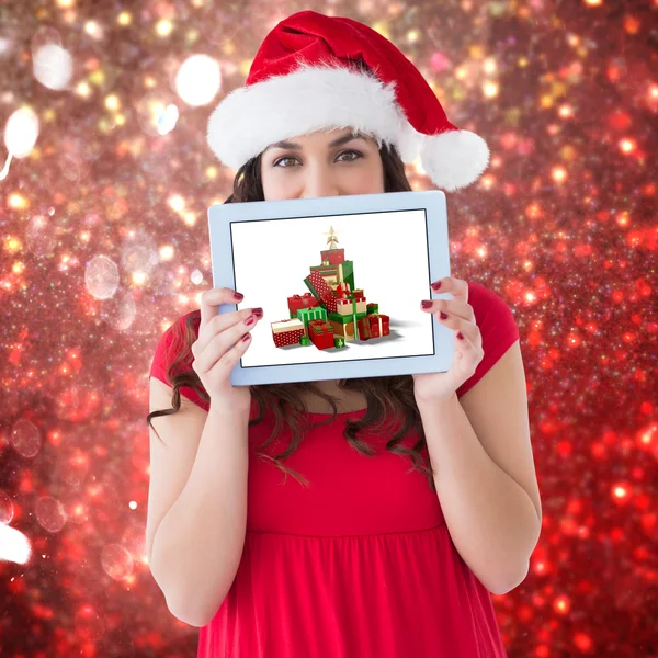 Morena festiva mostrando una tableta —  Fotos de Stock
