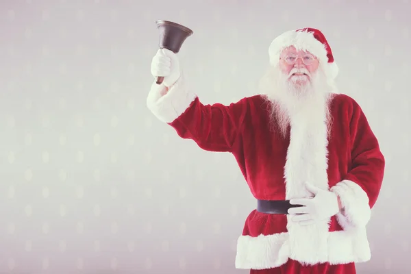 Composite image of santa claus rings his bell — Stock Photo, Image