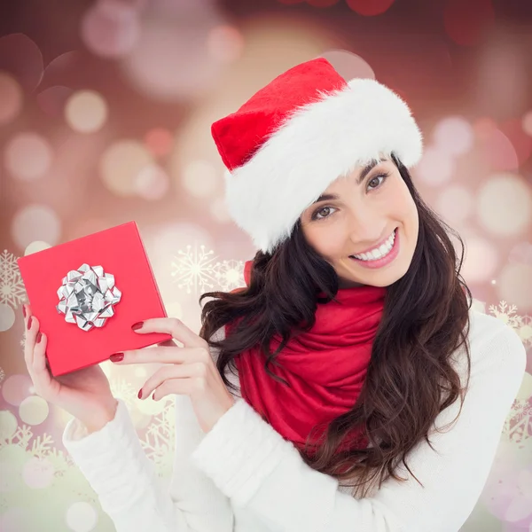 Joyful brunette presenting christmas gift — Stock Photo, Image