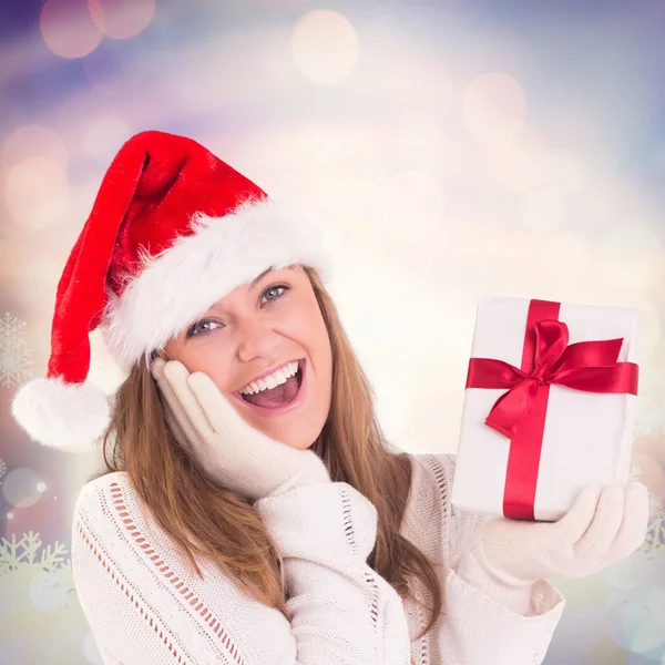 Festive blonde holding a gift — Stock Photo, Image