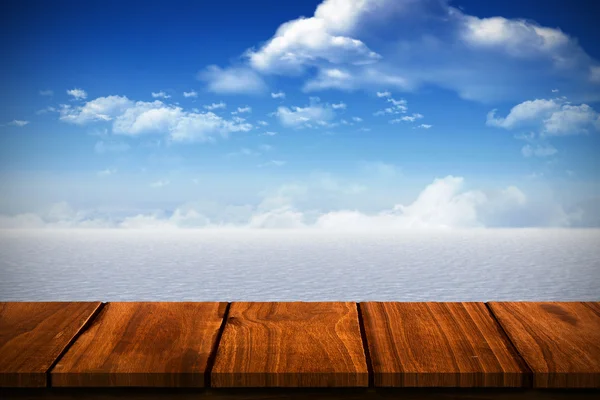 Wooden table against snowy landscape — Stock Photo, Image