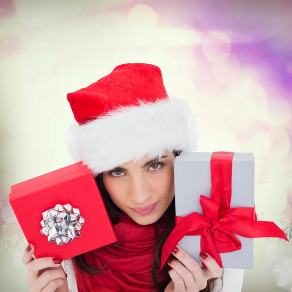 Brunette holding christmas gifts — Stock Photo, Image