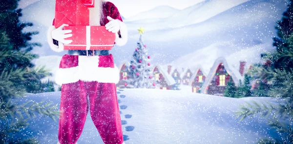 Composite image of santa carrying gifts — Stock Photo, Image