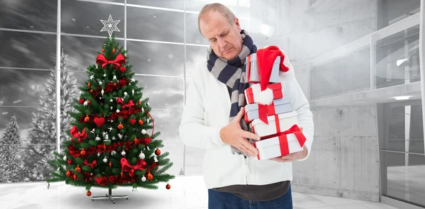 Festive man holding christmas gifts — Stock Photo, Image