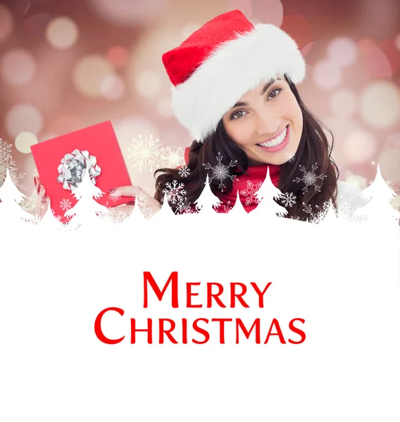 Joyful brunett framlägga julklapp — Stockfoto