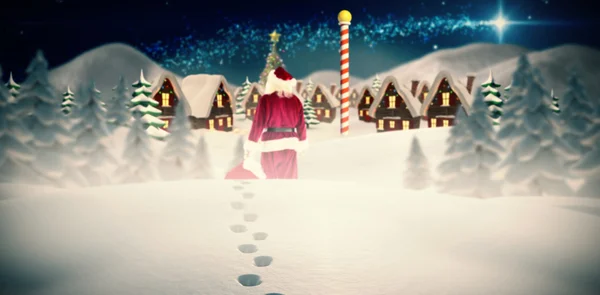 Santa carrying sack of gifts — Stock Photo, Image