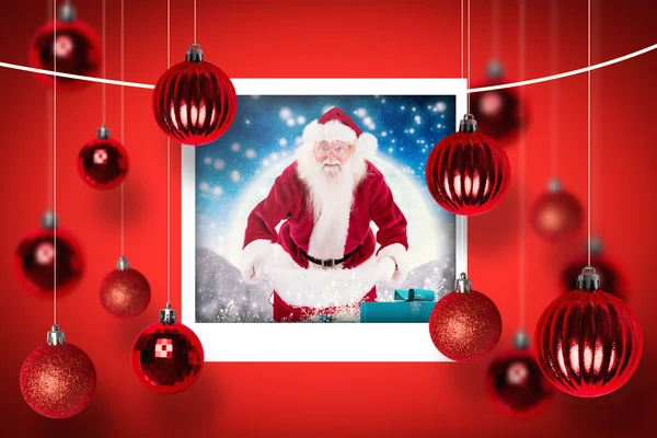 Složený obraz Santa otevřít svůj červený sáček — Stock fotografie