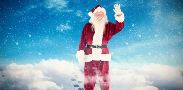 Composite image of jolly santa waving at camera — Stock Photo, Image