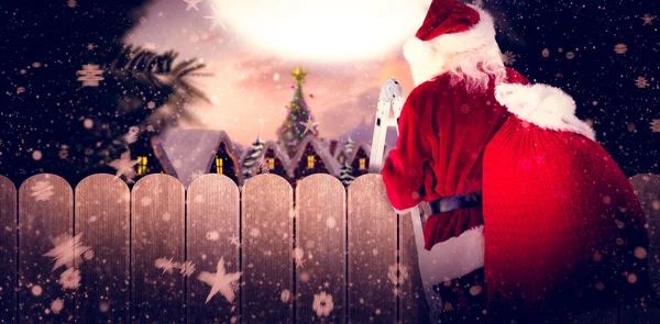 Santa stappen op ladder — Stockfoto