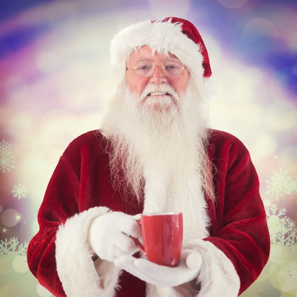 Santa holds red cup — Stock Photo, Image