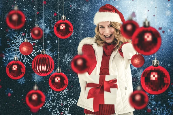 Festive blonde holding christmas gift — Stock Photo, Image