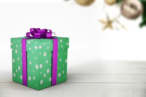 Green christmas present with purple ribbon — Stock Photo, Image