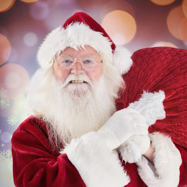 Jolly Santa draagt zijn zak — Stockfoto