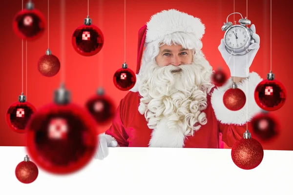 Sammansatta bilden av santa claus väckarklocka och tecken — Stockfoto