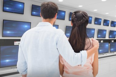 couple  looking against televisions for sale clipart