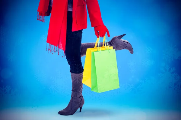 Happy blonde in winter clothes holding shopping — Stock Photo, Image