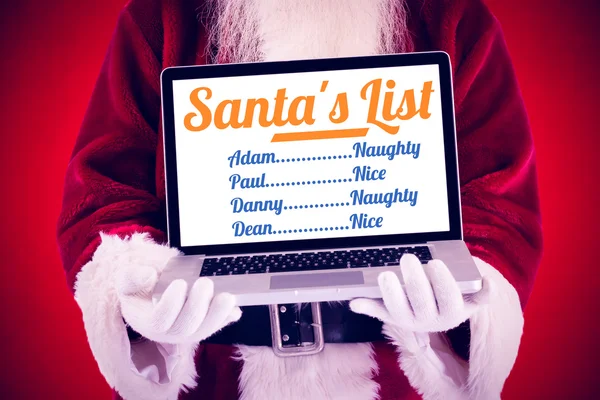 Santa Claus presenterar en laptop — Stockfoto