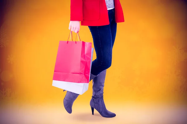 Happy blonde in winter clothes holding shopping — Stock Photo, Image