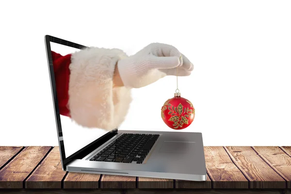 Santas hand håller en jul lampa — Stockfoto