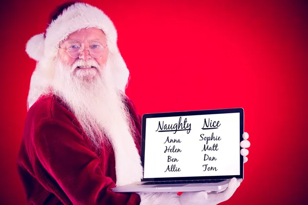 Santa claus presents a laptop — Stock Photo, Image