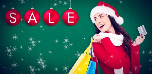 Festive brunette holding shopping bags — Stock Photo, Image