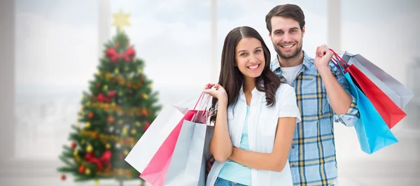 Feliz pareja con bolsas de compras —  Fotos de Stock