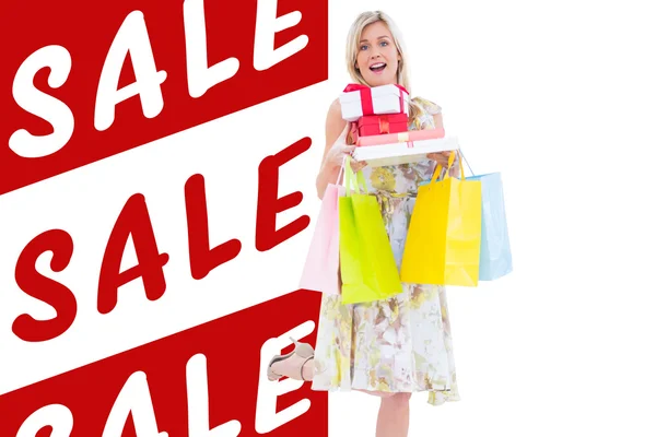 Elegant blonde with shopping bags and gifts — Stock Photo, Image