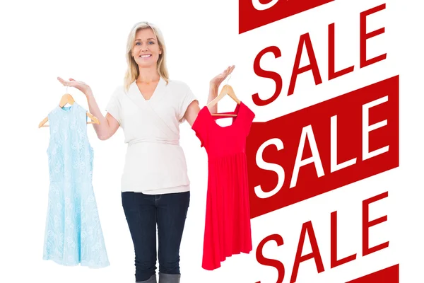 Pretty shopping blonde choosing a dress — Stock Photo, Image