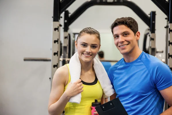 Woman standing with trainer — Stock Photo, Image