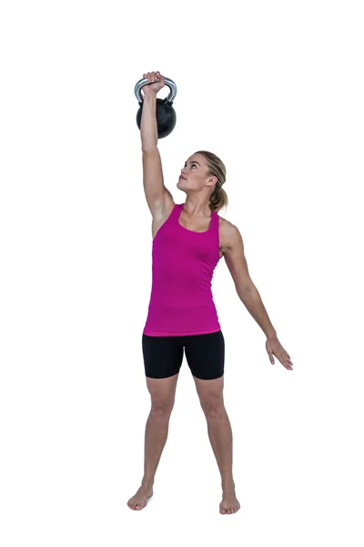 Muscular woman exercising with kettlebell — Stock Photo, Image