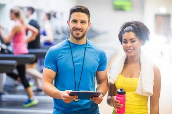 Entrenador y cliente sonriendo a la cámara — Foto de Stock