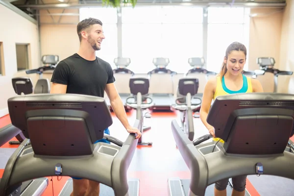 Man and woman using treadmills — Stock Photo, Image
